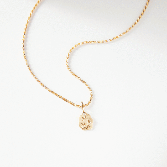 The Mama Charm in 10k yellow gold, studio detail view