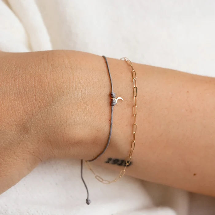 The Moon Phases Contemplation Cord Bracelet in 10k yellow gold with grey cord, alternate angle detail view