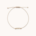 The Mother Contemplation Cord Bracelet in 10k yellow gold with cream cord