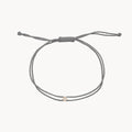 The Nova Diamond Grey Cord Bracelet in 10k yellow gold with diamond and grey nylon