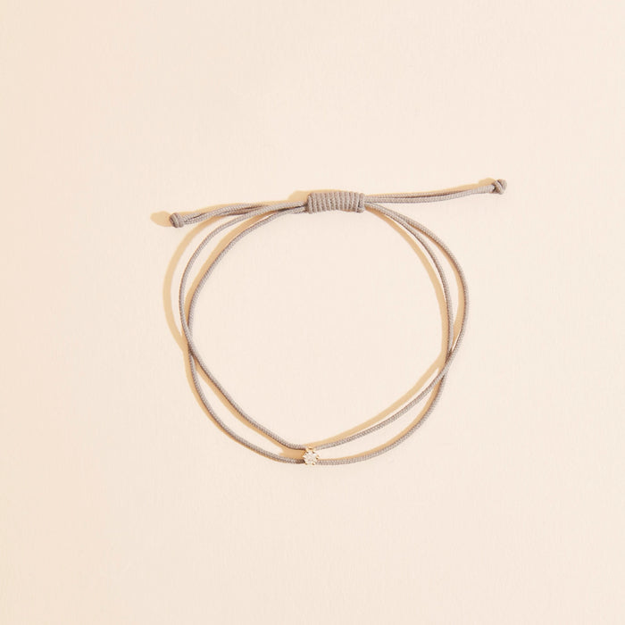 The Nova Diamond Grey Cord Bracelet in 10k yellow gold with diamond and grey nylon, alternate angle detail view 2
