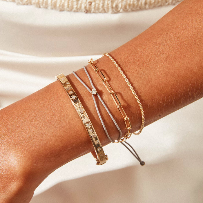 The Nova Diamond Black Cord Bracelet in 10k yellow gold with diamond and black nylon, alternate angle detail view