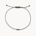 The One Cord Bracelet in 10k solid gold with grey cord