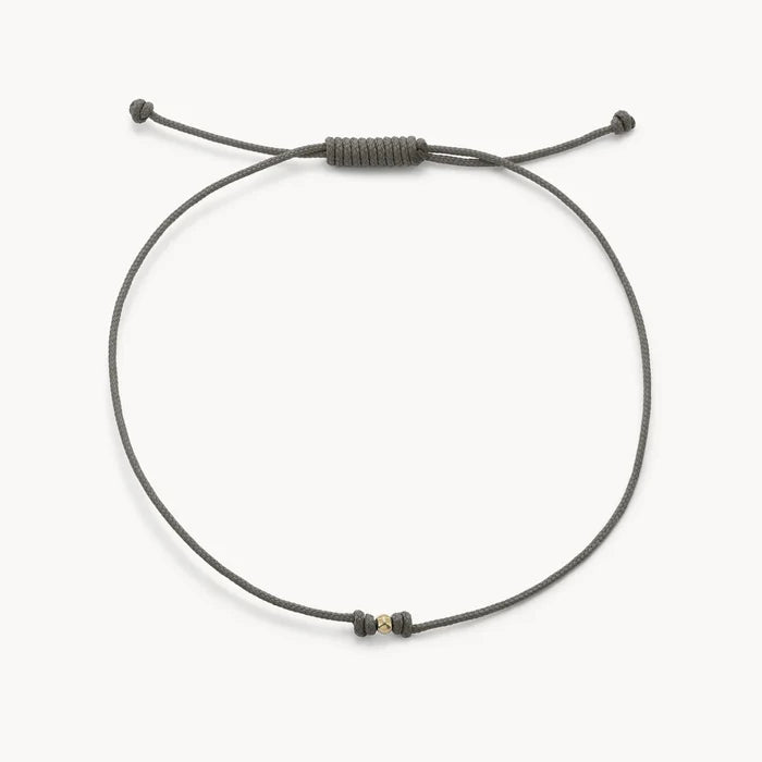 The One Cord Bracelet in 10k solid gold with grey cord