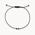 The One Cord Bracelet in 10k yellow gold with black cord
