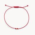 The One Cord Bracelet in 10k yellow gold with red cord