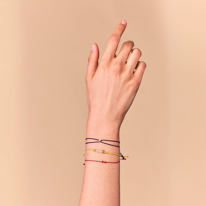 Safety Pin Cord Bracelet in 10k yellow gold with yellow cord, alternate angle detail view