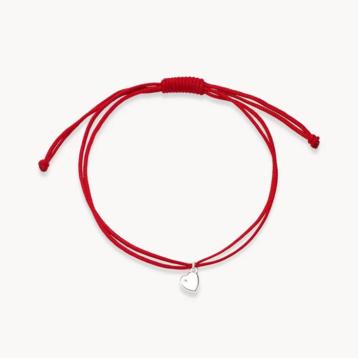 The Open Heart Cord Bracelet in sterling silver with diamond and light red cord