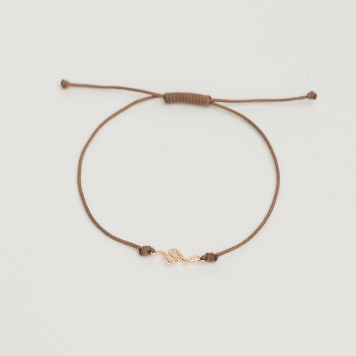The Serpent Contemplation Cord Bracelet in 10k yellow gold with taupe cord, alternate angle detail view 2