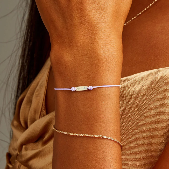 The Wild Heart Cord Bracelet in 10k yellow gold with lavender cord, alternate angle detail view