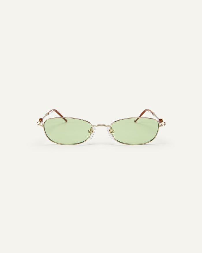 Face shot of Bonnie Clyde Tiptoe sunglasses in gold with green lenses.