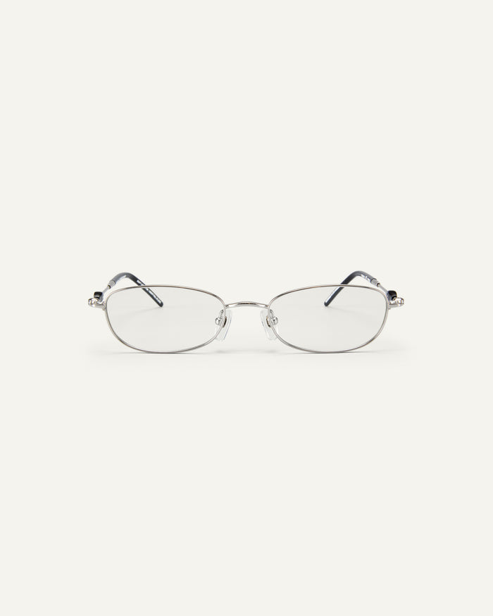 Face shot of Bonnie Clyde Tiptoe optical frames in silver and black with clear lenses.
