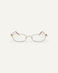 Face shot of Bonnie Clyde Tiptoe optical frames in gold with clear lenses.
