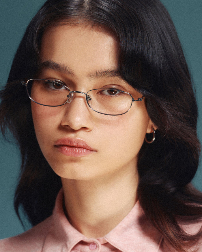Quarter shot of Bonnie Clyde Tiptoe optical frames in silver with clear lenses.