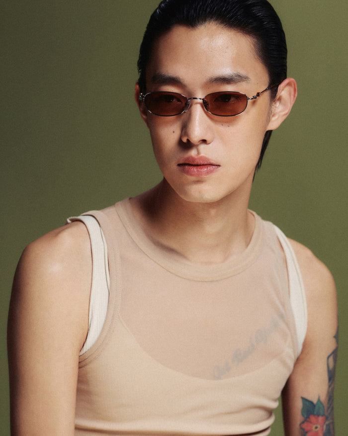 Quarter shot of Bonnie Clyde Tiptoe sunglasses in silver with brown lenses.