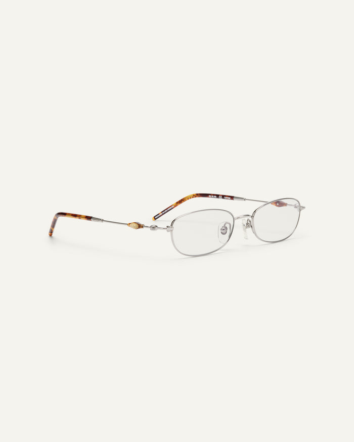 Side shot of Bonnie Clyde Tiptoe optical frames in silver with clear lenses.