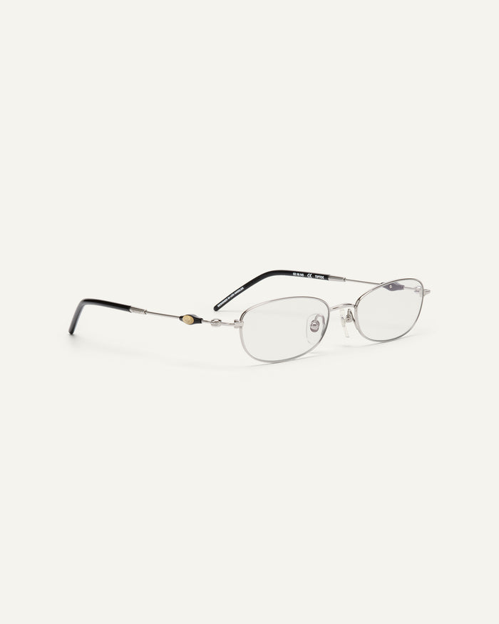 Close-up shot of Bonnie Clyde Tiptoe optical frames in silver and black with clear lenses.