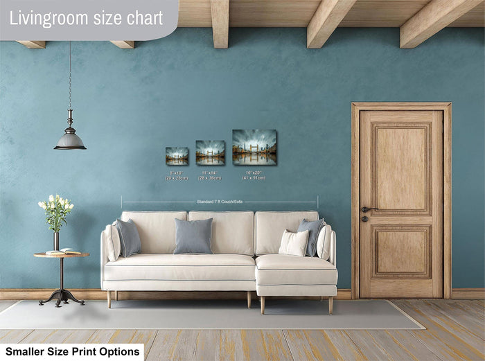 a living room with a white sofa, a wooden door, and a hanging light fixture. There are three framed artworks displayed on the wall, each with a different size and resolution. The living room appears to be designed for a smaller space, as indicated by the "Smaller Size Print Options" text at the bottom of the image.