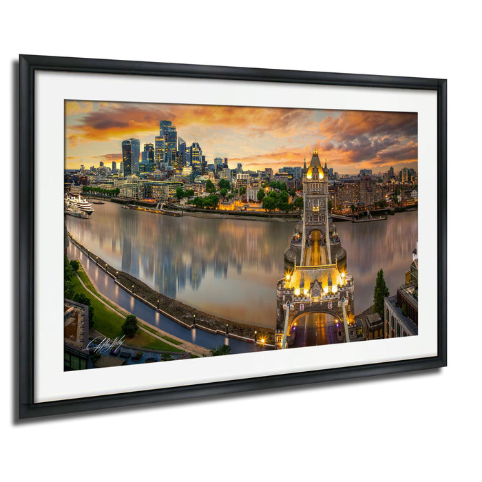 The image is a framed photograph of the London skyline at sunset, featuring the iconic Tower Bridge and the River Thames.