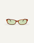 Face shot of Bonnie Clyde Trinket sunglasses in layered brown tortoise with green lenses.