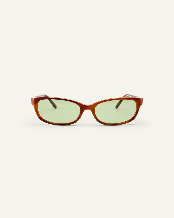 Face shot of Bonnie Clyde Trinket sunglasses in layered brown tortoise with green lenses.