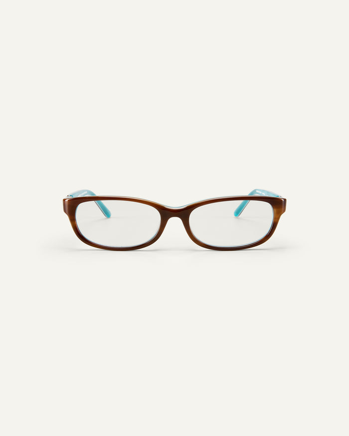Face shot of Bonnie Clyde Trinket sunglasses in layered teal demi with clear lenses.