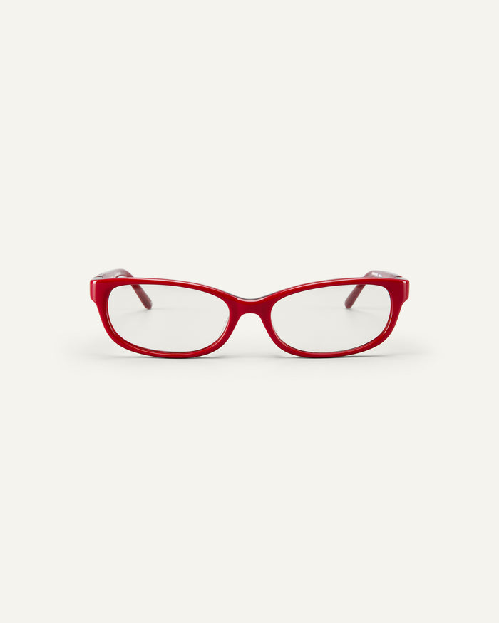 Face shot of Bonnie Clyde Trinket sunglasses in layered red with clear lenses.