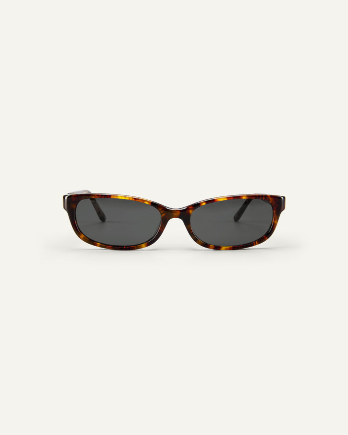 Face shot of Bonnie Clyde Trinket sunglasses in tortoise with black lenses.