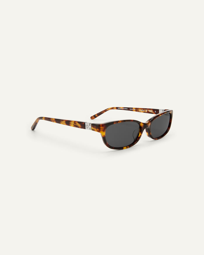 Quarter shot of Bonnie Clyde Trinket sunglasses in tortoise with black lenses.