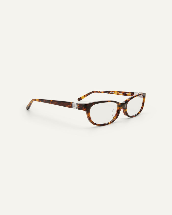 Quarter shot of Bonnie Clyde Trinket sunglasses in tortoise with clear lenses.