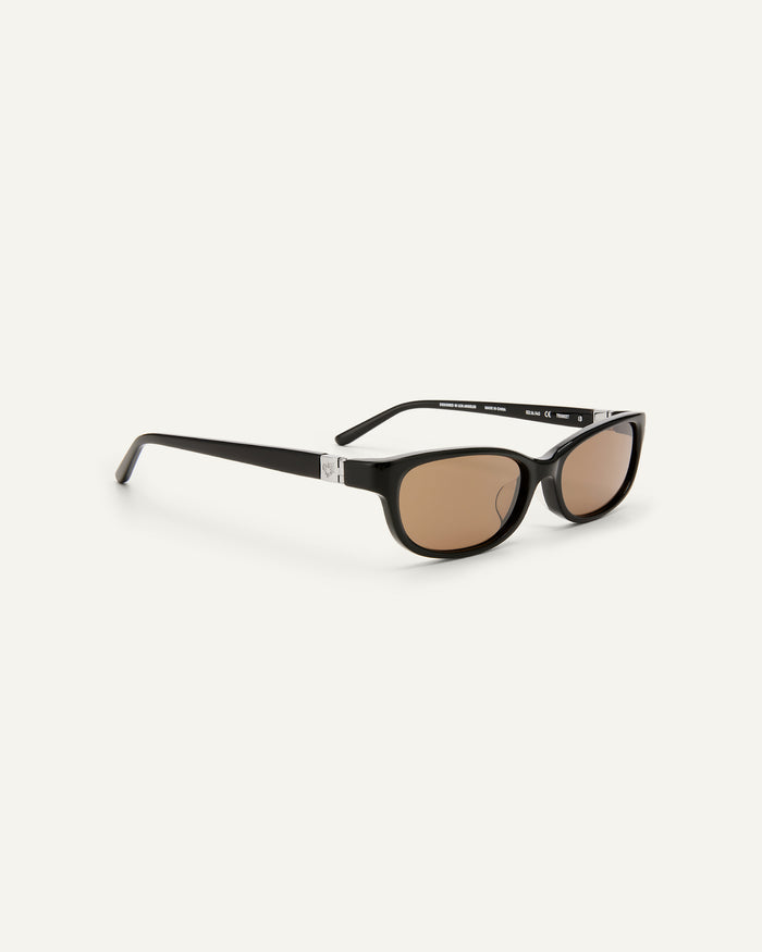 Quarter shot of Bonnie Clyde Trinket sunglasses in black with brown lenses.