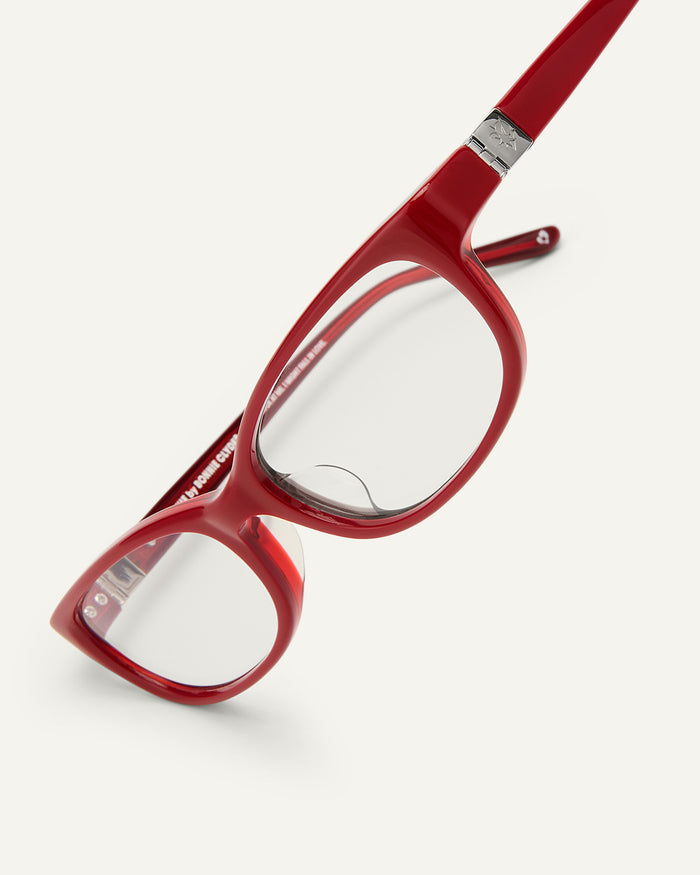 Side shot of Bonnie Clyde Trinket sunglasses in layered red with clear lenses.