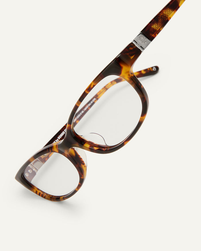 Side shot of Bonnie Clyde Trinket sunglasses in tortoise with clear lenses.