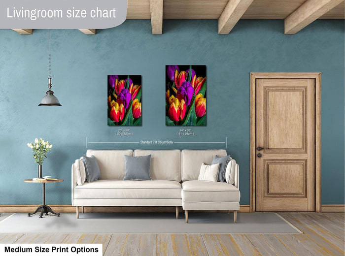 a living room with a white sofa, a wooden door, and a painting of colorful tulips hanging on the wall.