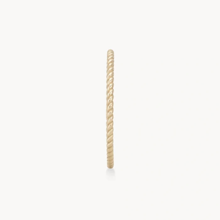 A close-up view of a twisted stacking ring - 10k yellow gold by bluboho featuring a twisted rope design, displayed against a plain white background.
