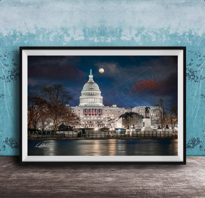 the United States Capitol building at night, with the moon visible in the sky.