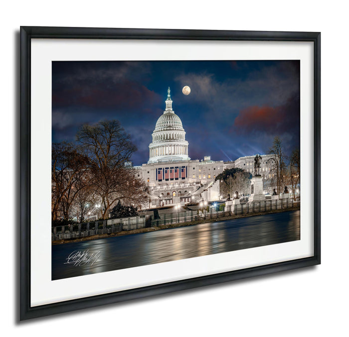 the United States Capitol building at night, with the moon visible in the sky.