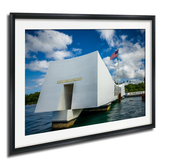 the memorial at Pearl Harbor, Hawaii, with the American flag flying in the background.