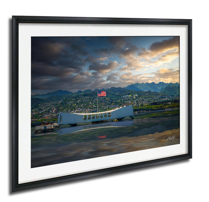a large white structure with a curved roof, possibly a monument or building, situated in a mountainous landscape with a cloudy sky and a sunset in the background.