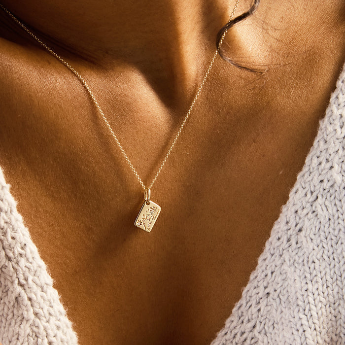 Vancouver Postcard Charm in 10k yellow gold with brilliant diamond, shown worn on hand