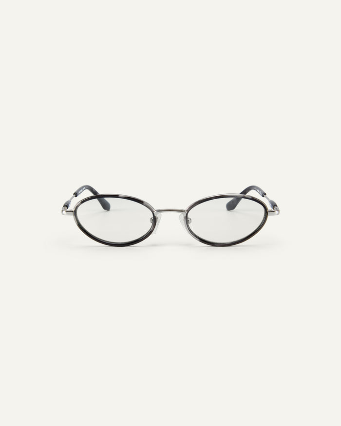 Face shot of Bonnie Clyde Voodoo optical frames in silver and black tortoise with clear lenses.