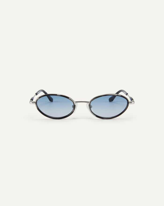 Face shot of Bonnie Clyde Voodoo sunglasses in silver and black tortoise with blue gradient lenses.