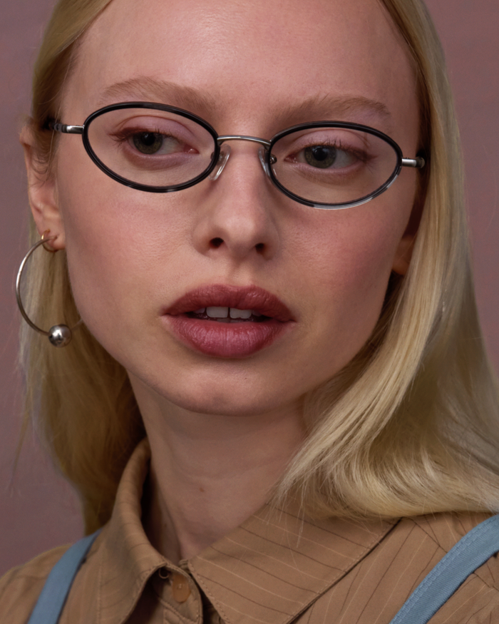 Quarter shot of Bonnie Clyde Voodoo optical frames in silver and black tortoise with clear lenses.