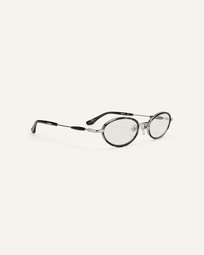 Side shot of Bonnie Clyde Voodoo optical frames in silver and black tortoise with clear lenses.