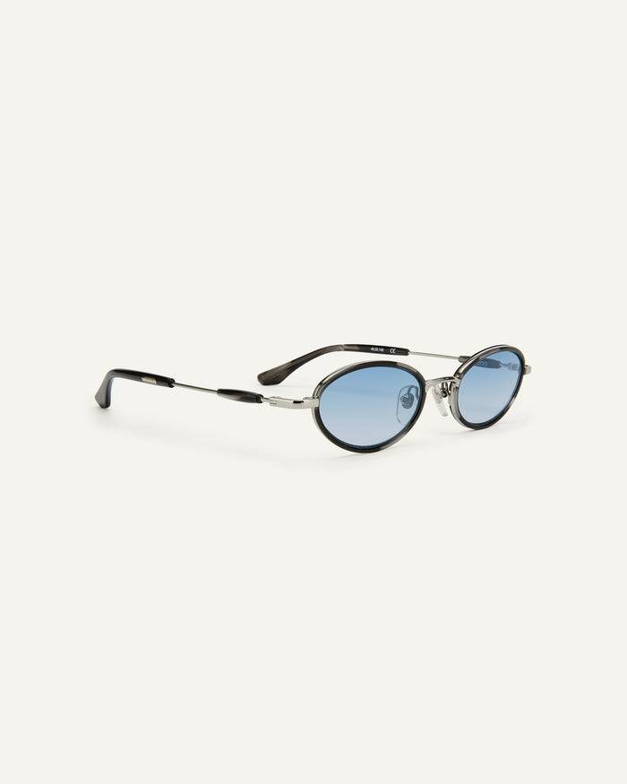 Side shot of Bonnie Clyde Voodoo sunglasses in silver and black tortoise with blue gradient lenses.