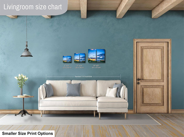 a living room with a white sofa, a wooden door, and a hanging light fixture. Above the sofa, there is a size chart indicating the dimensions of the artwork displayed on the wall.