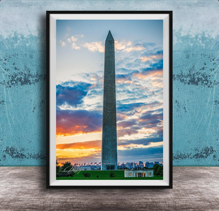 the Washington Monument, a tall obelisk, against a colorful sunset sky with clouds.