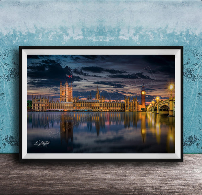 a city skyline at night, with the buildings illuminated and reflected in the water below.