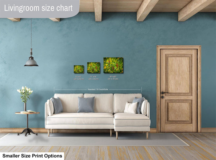 a living room with a white sofa, a wooden door, and a hanging light fixture. There are three framed artworks displayed on the wall, each with a different size and resolution. The living room appears to be designed for a smaller, more intimate space.