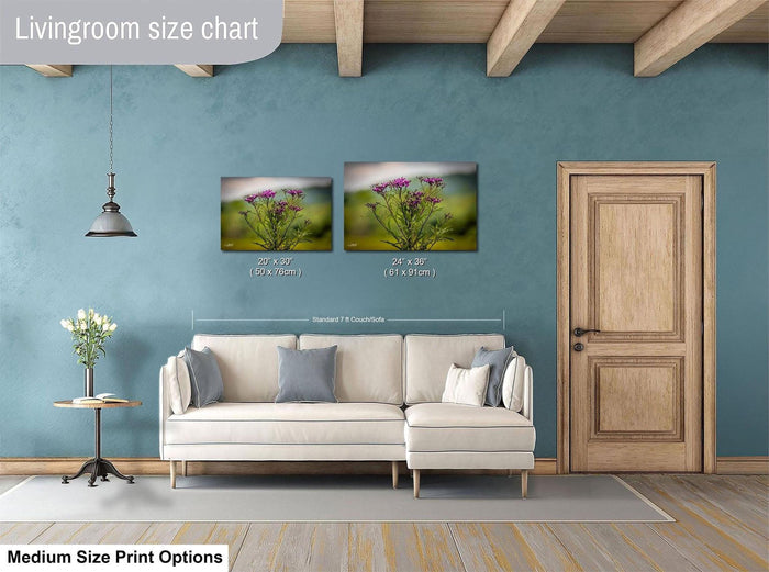 a living room with a white sofa, a wooden door, and a painting of flowers on the wall. The living room appears to be well-decorated and spacious.